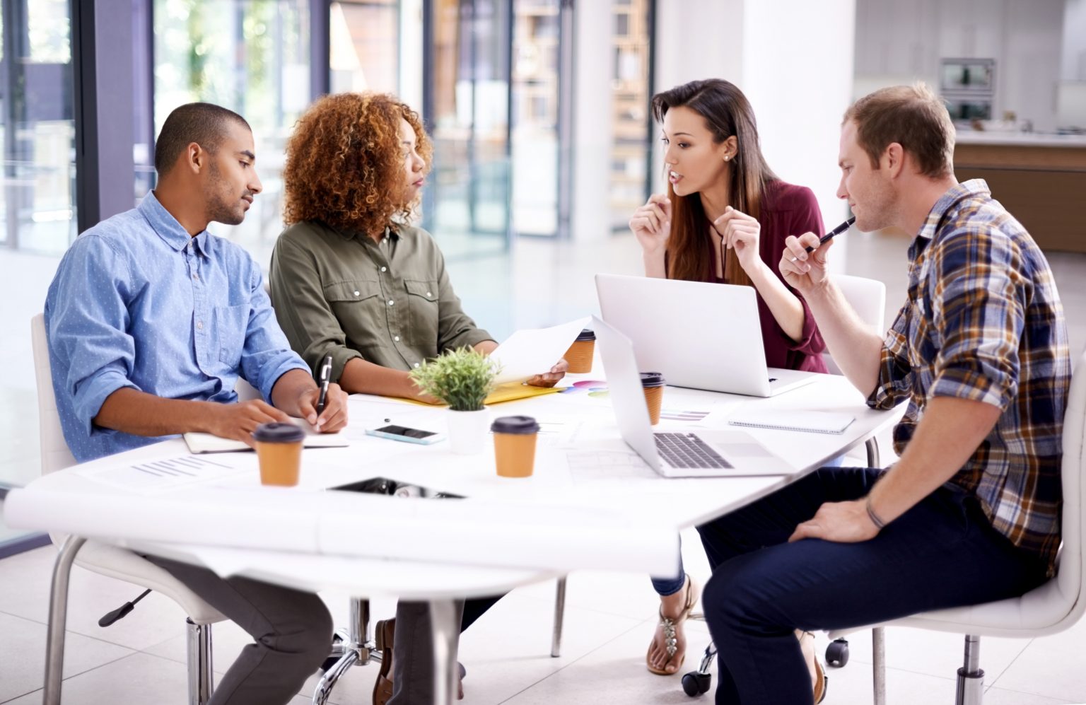 Fulfilled employees collaborating at work for greater productivity, profit.